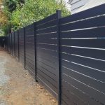 Modern horizontal aluminum fence with evenly spaced gaps installed next to a residential home in Shoreline, WA