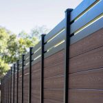 Black aluminum fence frame with dark brown composite slats