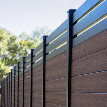 Black aluminum fence frame with dark brown composite slats