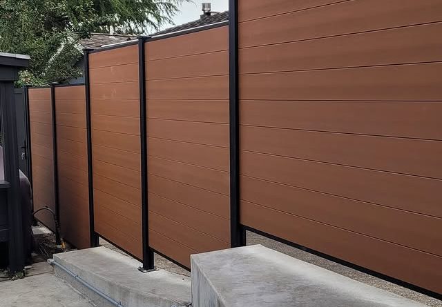 Modern composite fencing panels with black aluminum posts in Mercer Island