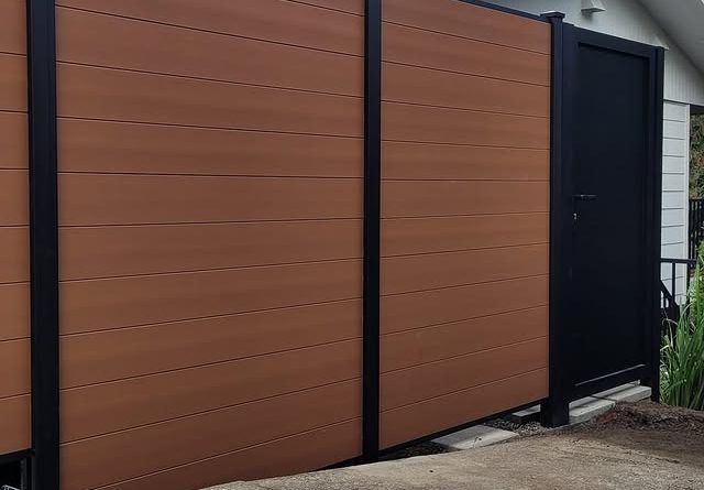 Horizontal brown composite privacy fence with black aluminum gate in Mercer Island